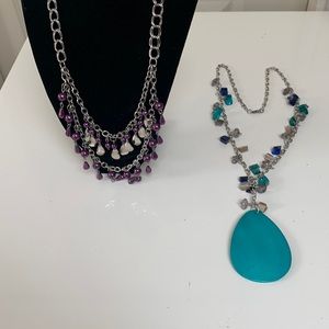 2 necklace’s.Silver tone.One purple with silver.Second one with stone